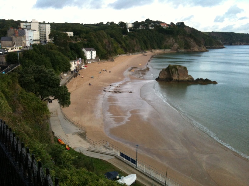 The beach. Swim around that rock tomorrow and then run up the cliff and across town!